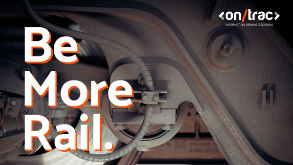 Closeup shot of a train wheel mechanism with text overlayed saying 'Be More Rail'